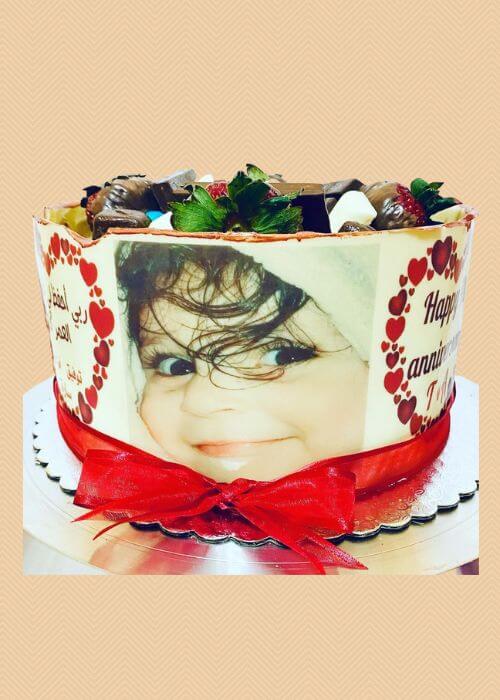 A custom photo cake for a baby girl.